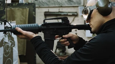 Man trains to shoot at the shooting range Stock Footage 120246516