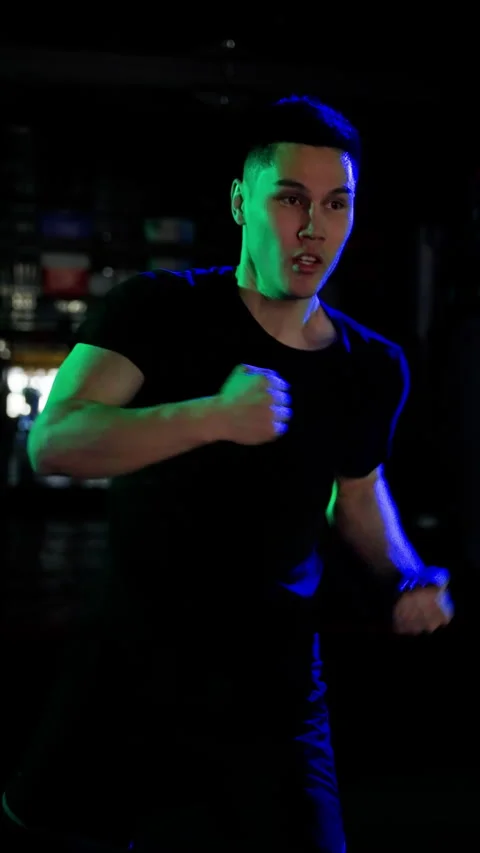 A man trains without gloves. Boxing punches in slow motion. Vertical video. Stock Footage 260149030