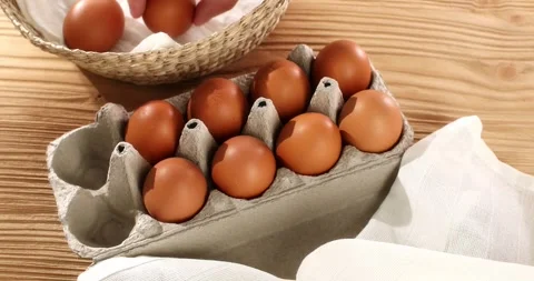 Man transfers eggs from a basket to a package. Close-up. High angle view. Stock Footage 242855020