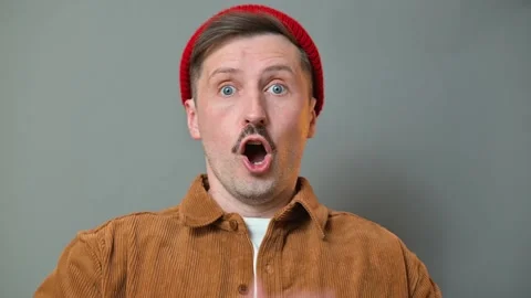 A man transitions through distinct facial expressions, portraying surprise, , Vidéo 337642614