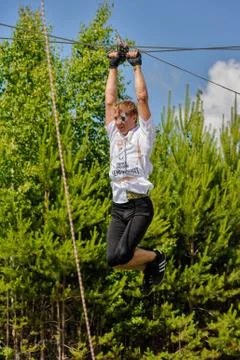 Man is transported on rope through the river Stock Photos