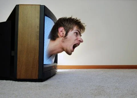 A man trapped inside of a tv, screaming for help to get out Stock Photos