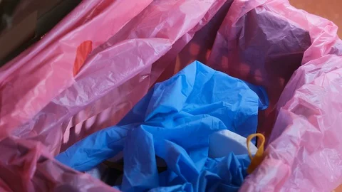 Man trash protective mask and gloves on separate garbage bin,covid19 disease Stock Footage 130033336