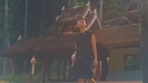 Man traveler with camera at ancient Buddhist temple in Chiang Mai, Tourist Stock Footage 346025167