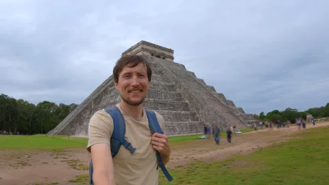 Man traveler is walking in front of Kukulkan pyramid in Chichen Itza, Mexico Stock Footage 338247453