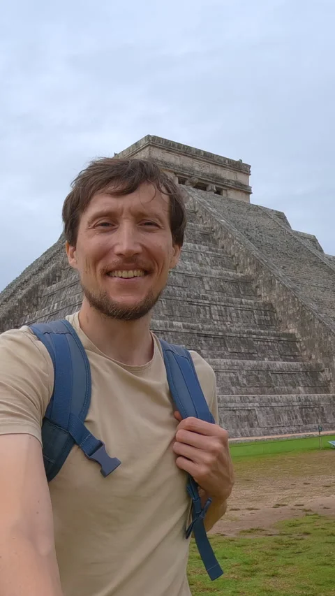Man traveler is walking in front of Kukulkan pyramid in Chichen Itza, Mexico Stock Footage 345176667