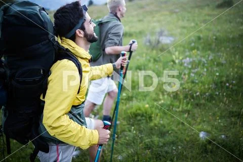 Man traveling with backpack hiking in mountains Stock Photos