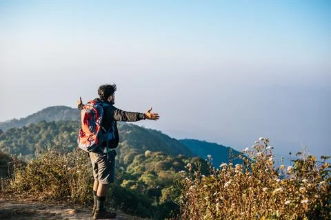Man traveling with backpack hiking in mountains Stock Photos