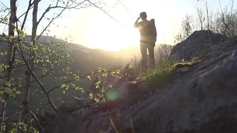 Man traveller watches sunset, slow motion. Slide up. Nature reserve.Eco-friendly 動画素材 144054853