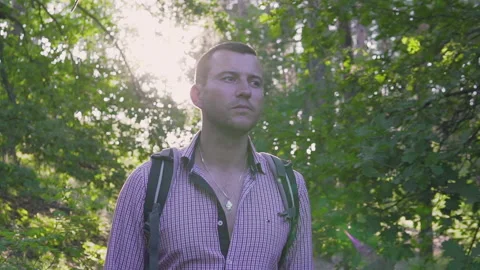 A man travels with a backpack on his back against the backdrop of a sunset in th Stock Footage 134801573