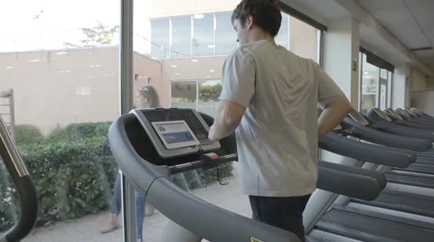Man on treadmill running machine in the gym Stock Footage 46264349