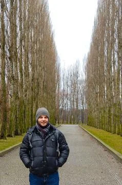 Man on tree-lined winter path at Treptower Park Berlin. Stock Photos