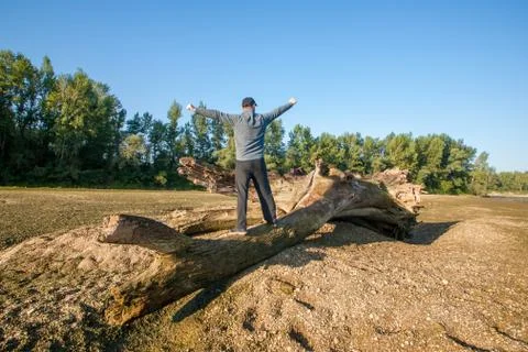 A man on a tree trunk Photos