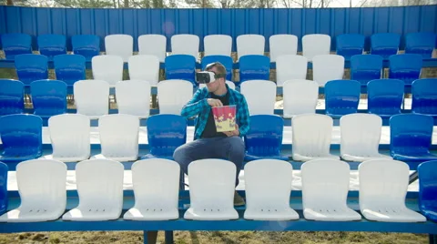 Man on the tribune in VR glasses upsetting with the things around Stock Footage 63841288