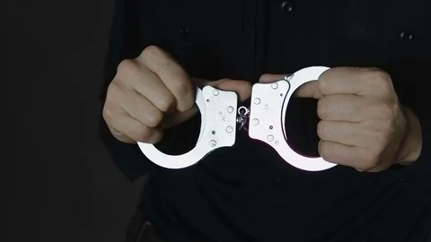 Man Tries To Break the Handcuffs Stock Footage 73035949