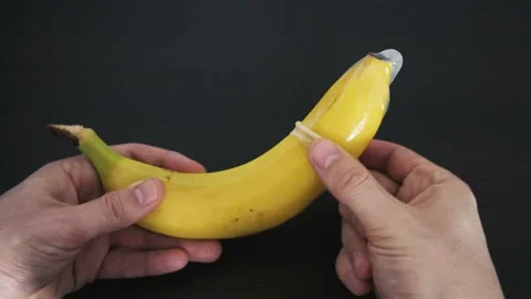 A condom is stretched over a banana. The... | Stock Video | Pond5