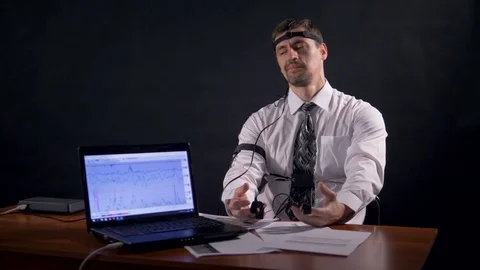 A man tries to cheat polygraph by making a joke. Stock Footage