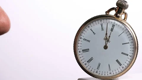 A man tries to check if the time smells and sniffs the clock Video stock 85883686