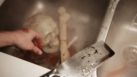 Man tries to clean up bones to keep as gruesome souvenir after massacre and slau Stock-Footage 117743222