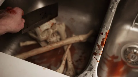 Man tries to clean up bones to keep as gruesome souvenir after massacre and slau Vídeo Stock 117745568