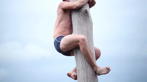 Man tries to climb up the pole Stock-Footage 62077265
