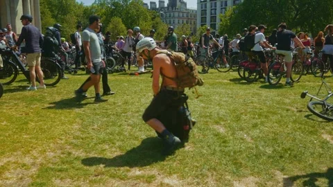 Man tries to learn how to ride on electric unicycle in Wellington Arch in London Stock Footage 246352264