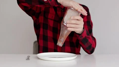 A man tries to pour ketchup from an empty bottle Stock Footage 320077266