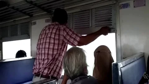 A man tries to pull down the blinds on the train 動画素材 341454340
