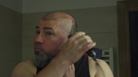 Man Trimming Both His Head Hair and Beard with Electric Clipper Stock Footage 337164641