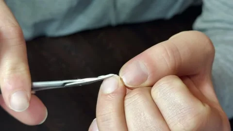 A man trims and files his fingernails Stock-Footage 306530774