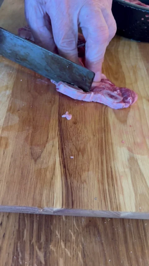 A man trims short rib meat closeup vertical Stock Footage 242513482