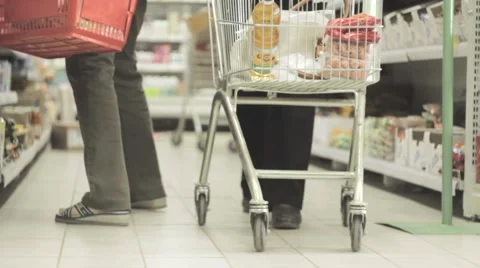 A man with a trolley in the store. A man with a basket in the store. Stock Footage 50099604