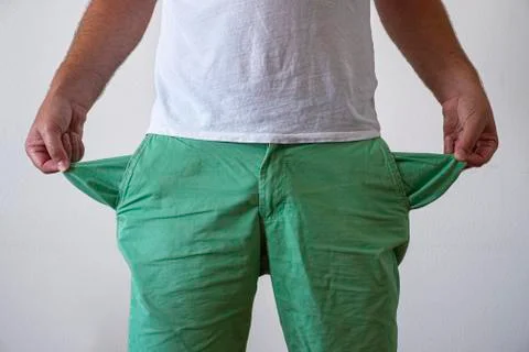 A man in trousers with empty pockets turned out. Stock Photos