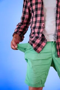 A man in trousers with empty pockets turned out. Stock Photos