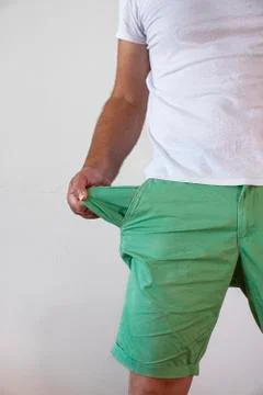 A man in trousers with empty pockets turned out. Stock Photos
