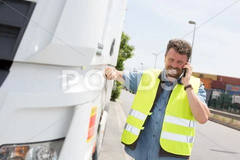 Man truck driver working with his smartphone Stock Photos