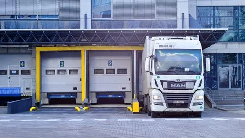 MAN truck is loading or unloading under the ramp. Stock Photos