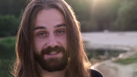 Man try to growling at camera river shore background Stock Footage 120468020