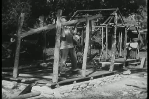 Man trying to build house frame Stock Footage