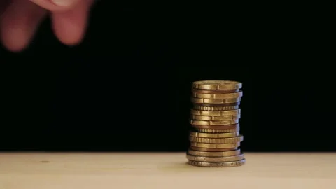 A man trying to catch a coin Video stock 168571018