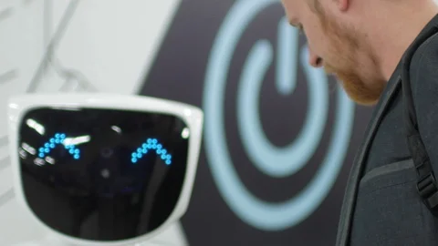 Man trying to communicate with a robot, modern robotics technique Stock Footage 92811833