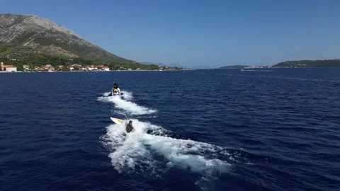 Man Trying to do surfing behind a jetski 스톡 동영상 216914571