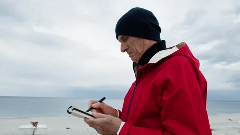 Man Trying To Draw The Surrounding On Paper Stock Footage 282043423