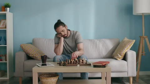 Man Is Trying to Entertain by Playing Chess Stock Footage 130453920