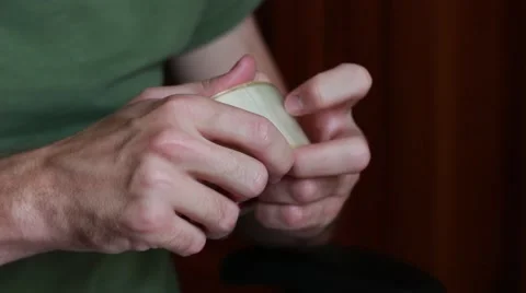 Man trying to find the edge of sticking tape Vídeo Stock 65371879