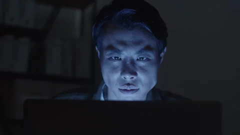 Man Trying to Hack Computer System at Nighttime Stock Footage 256981091