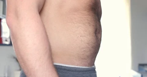 Man trying to hide his belly Stock Footage 106256920