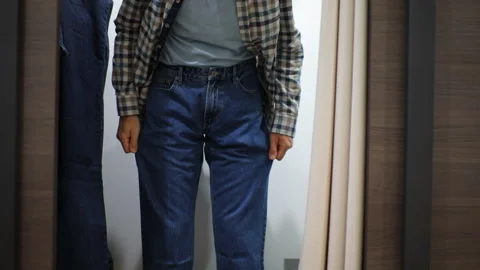 Man trying jeans Stock Footage 97764135