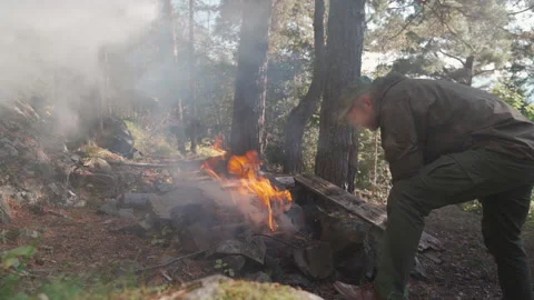 Man is trying to make a fire in the forest Video stock 160437493