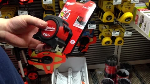 Man trying a new 16 FT tape measure Stock Footage 53127364